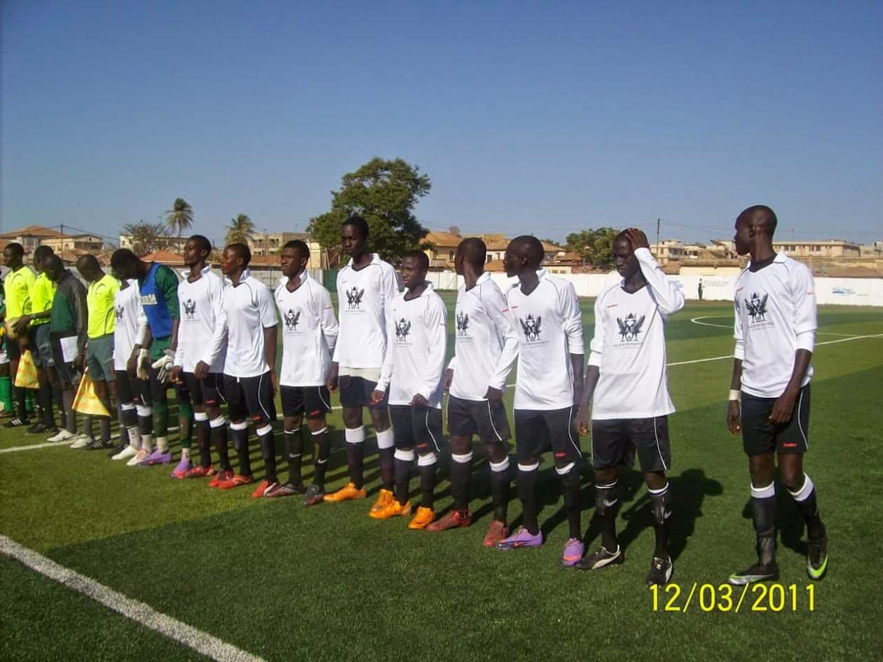Two teams lined up on the pitch before a festival match in The Gambia, March 2011